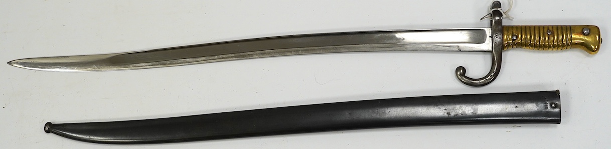 A Chassepot French bayonet in its steel scabbard, dated 1872. Condition - good